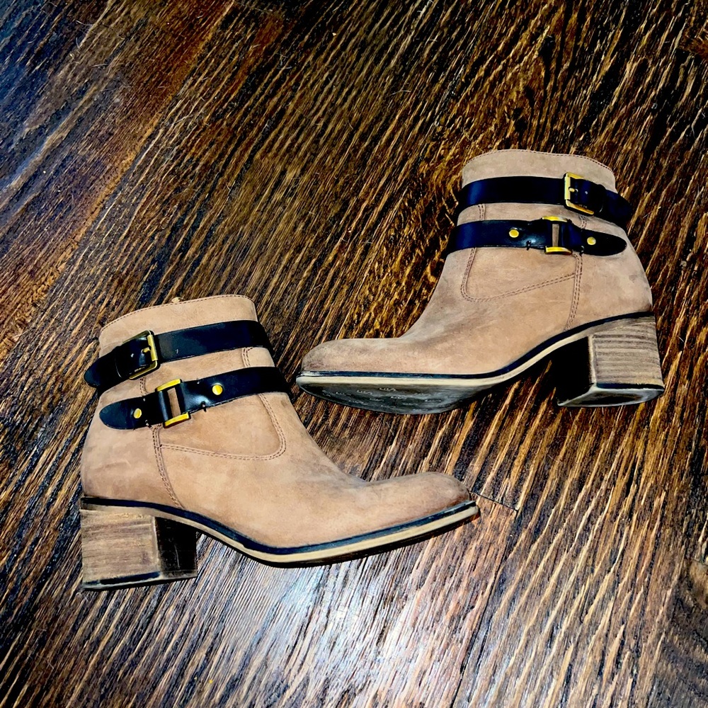 Franco Sarto brown ankle booties with side buckle details.